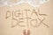 Person`s Foot Near The Digital Detox Text Wave On Beach