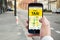 Person\'s Hand Booking Taxi On Smart Phone