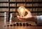 A person\\\'s hand holding a light bulb in front of stacks of coins, representing the concept of energy efficiency