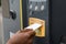 Person`s Hand Inserting Ticket Into Parking Machine