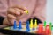 A person& x27;s hand while playing ludo on the board