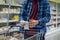 a person\'s hands holding a check list and read the food title in grocery store