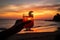 person, savoring exotic cocktail with view of the sunset on the beach