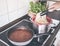 Person serving pasta and bolognese sauce on stove