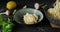 Person serving pasta with white sauce, putting spaghetti on plate using fork and spoon from pan, 4k footage, high