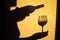 Person Shadow Holding A Wine Glass On Wall. Shadow Of man Drinking Wine