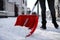 Person shoveling snow outdoors on winter day, closeup