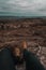 Person sitting on the mountains of Mallin, enjoying the view of Cordoba, Argentina