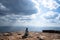 A person sitting on rocky mountain looking out at scenic natural view