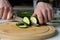 person slices a cucumber