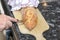 Person slicing a freshly baked loaf of bread