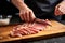 a person slicing sesame seared tuna