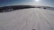 Person snowboarding from a snowy slope. Snowboarder on board rides a mountain.