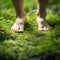 A person standing on the grass with their bare feet, AI