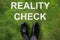 Person Standing Next To Reality Check Text