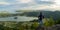 Person standing overlooking a beautiful lake