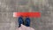 Person standing on tiled floor with a red line. Concept of keep distance, social distancing