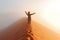 Person standing on top of dune in desert and looking at rising sun in mist with hands up, travel in Africa