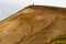 Person standing on the top of a sandy hill