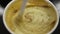 Person stirring aromatic coffee with fluffy foam, cup of hot cappuccino closeup