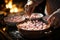 Person stirring a pot of hot cocoa with marshmallows - stock photography concepts