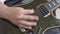 Person strikes the strings of electric guitar using a pick, close up. Musician finishes practicing favorite song or