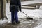 Person sweeping snowy street