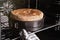 Person taking delicious fresh homemade cake from oven