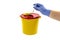 A person throwing away a syringe into a medical waste container