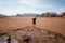 Person on a top of mountains in a desert. Sunset view. Nature. Tourist people enjoy a moment in a nature. Wadi rum national park -