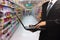 Person typing on laptop in supermarket in blurry