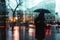 person with an umbrella, rainy cityscape reflected on glass