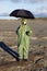 Person with umbrella waits radioactive rain