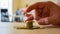 A person uses his fingers to flick a coin stack.