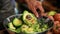 A person is using a knife to cut into an avocado, preparing it for consumption