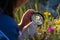 person using a magnifying glass to examine flowers