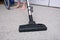 A person vacuuming the carpet in the house, cleaning rug with the vac concept