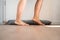 Person Walking Barefoot Near Draft Excluder Under Door