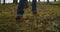 Person is walking in a forest. Close up focus on boot or hiking shoes. Close up view of man legs walking in the summer
