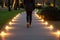 person walking on pathway with led lights lining the sides