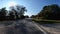 Person walking POV driving Country paved road fall colors in rural Georgia USA