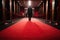 person, walking red carpet before grand opening of movie theater or concert hall