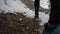 Person walking on a snowed mountain trail in winter