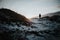 Person walking at Stokksnes, Iceland at sunset