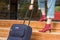 Person walking up on wooden Stairs pulling Travel Suitcase