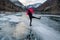 A person walks across a frozen lake