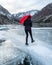 A person walks across a frozen lake