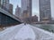 Person walks alone on snow-covered riverwalk alongside a steamy Chicago River as temps plunge