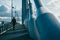 Person walks on an industrial bridge with large pylons and cable ties