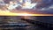 Person walks on pier at sunset